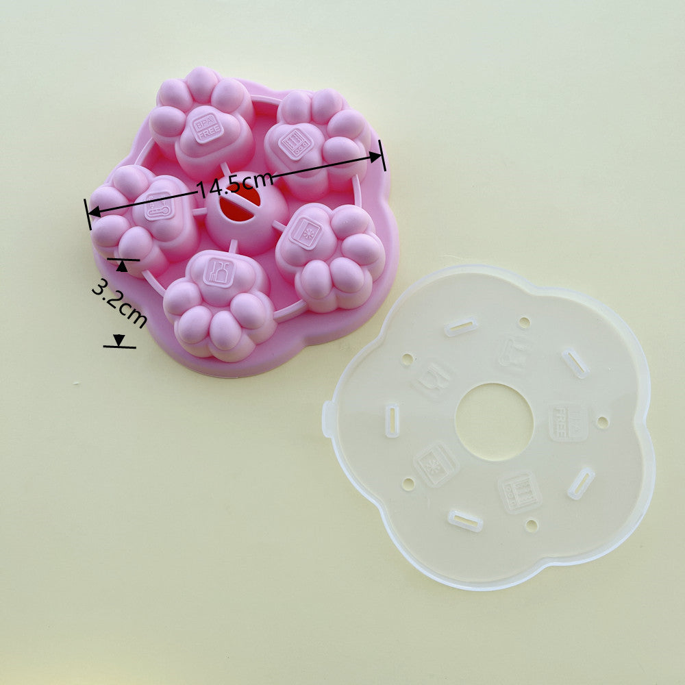 A pink paw-shaped silicone mold with dimension markings (14.5 cm by 3.